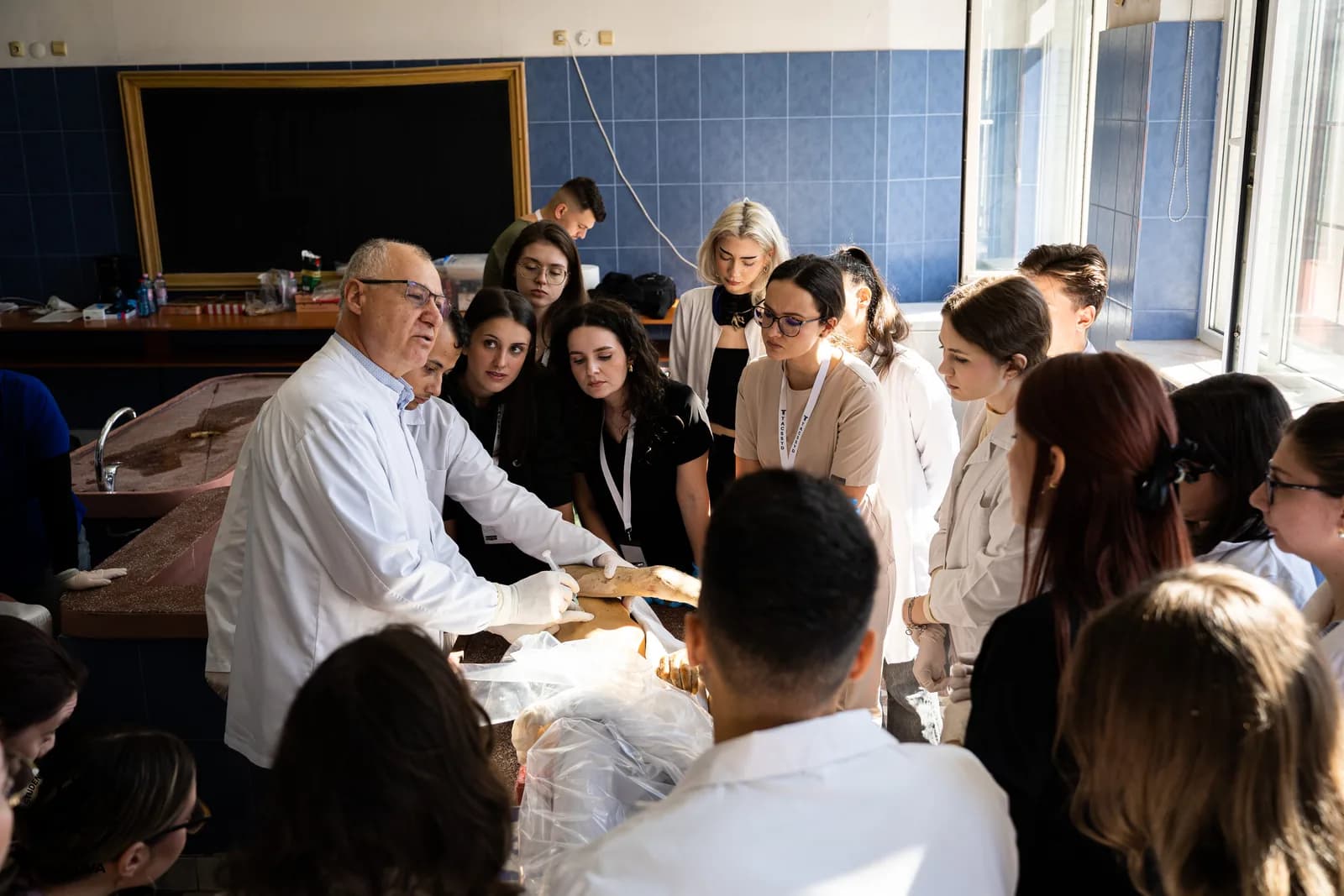 Students following a live surgical anatomy demonstration