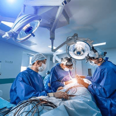 Surgical team operating under theatre lights