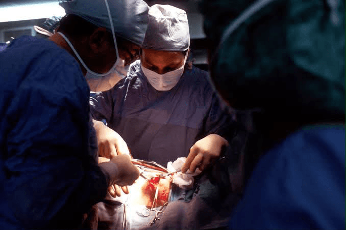 Surgeons at work around an operating table